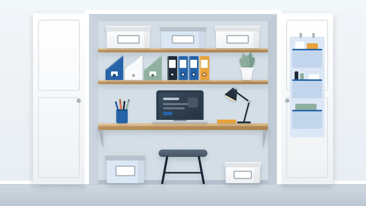 Open closet used as an office nook with a desk surface across its width, a laptop and lamp, two shelves of boxes above and a stool below