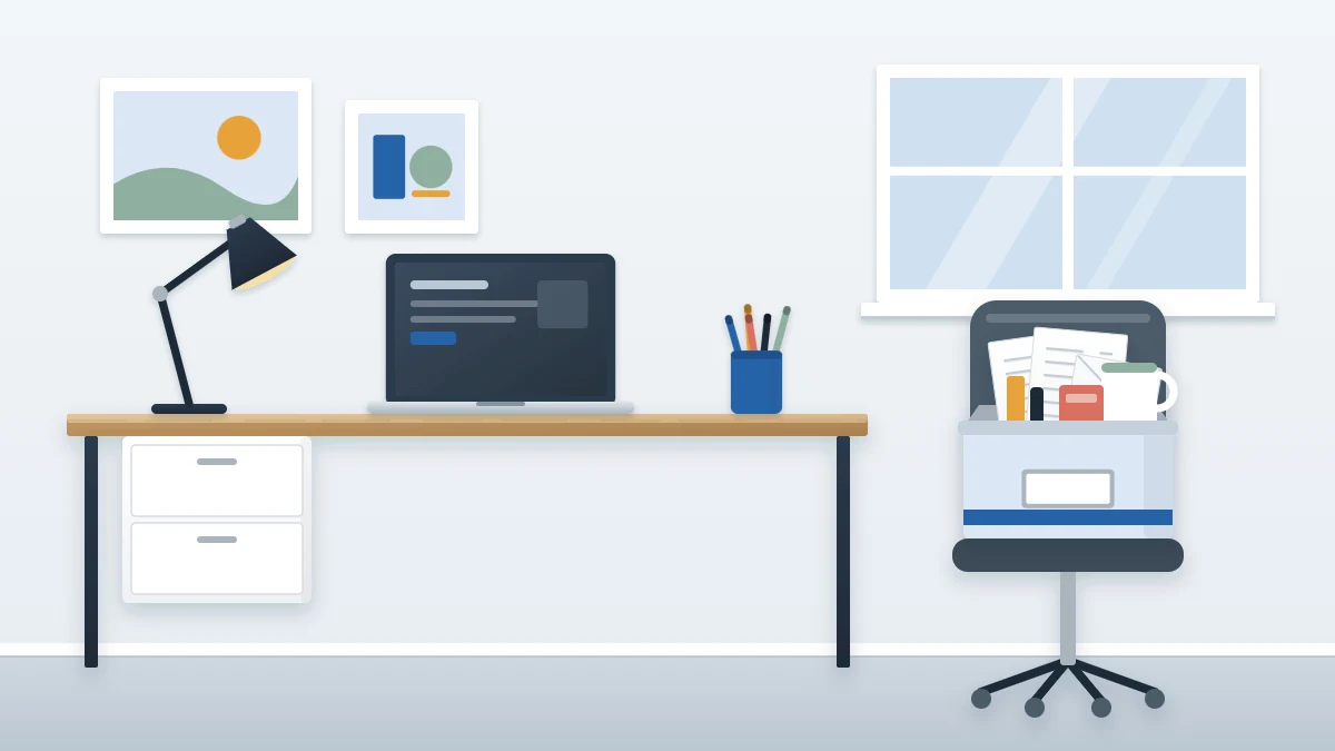 Cleared desk holding only a laptop, lamp and pen cup, with an open box of removed papers, mugs and odds and ends on a chair beside it