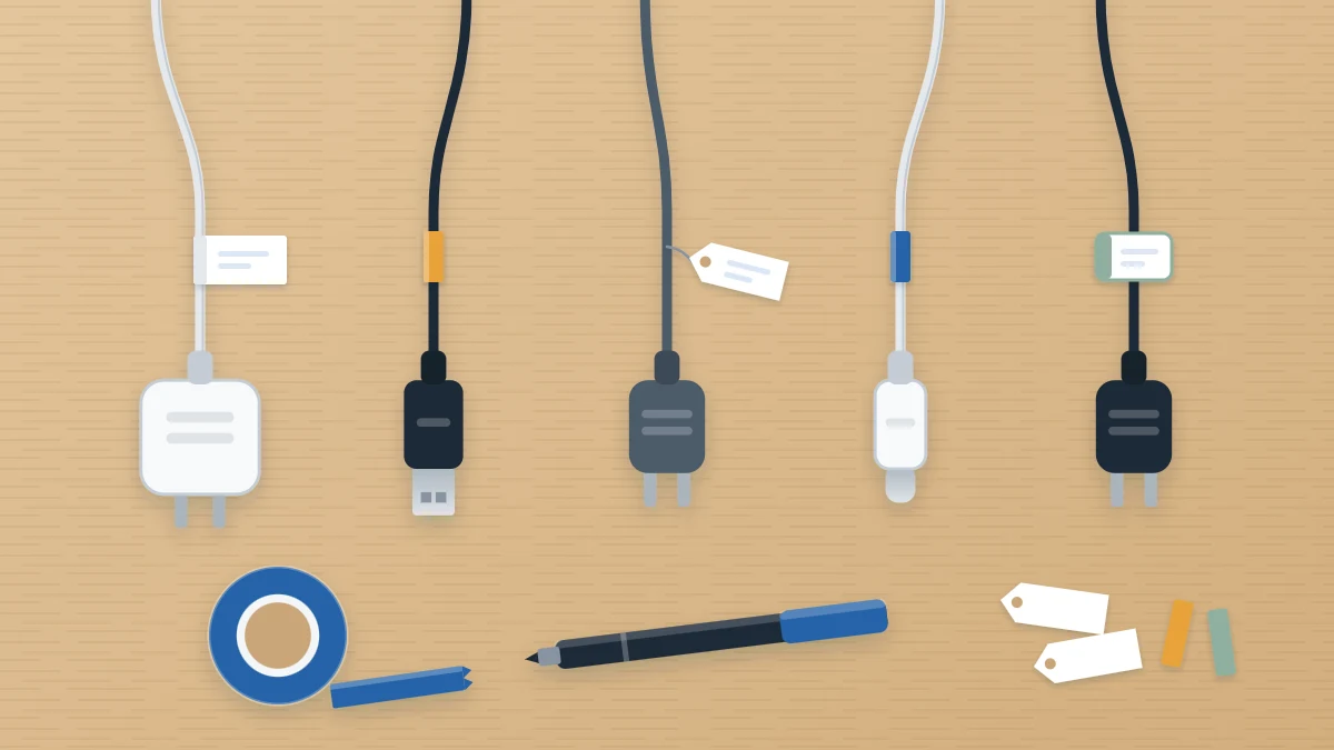 Five plugs in a row, each cord with a small blank tag or colored tape band near the plug, with a roll of tape and a marker