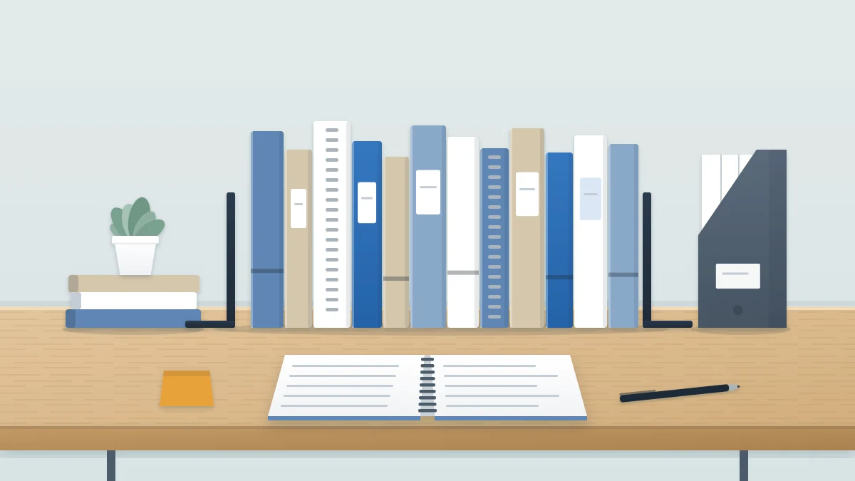 Row of notebooks upright between two bookends on a shelf in blue, sand and white, with an open spiral notebook and pen