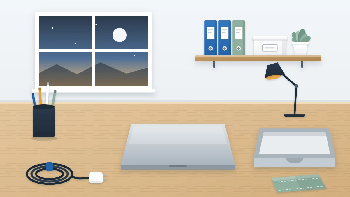 Clear desk at the end of the day with a closed laptop, pen cup, empty letter tray, coiled charger cable and folded cloth