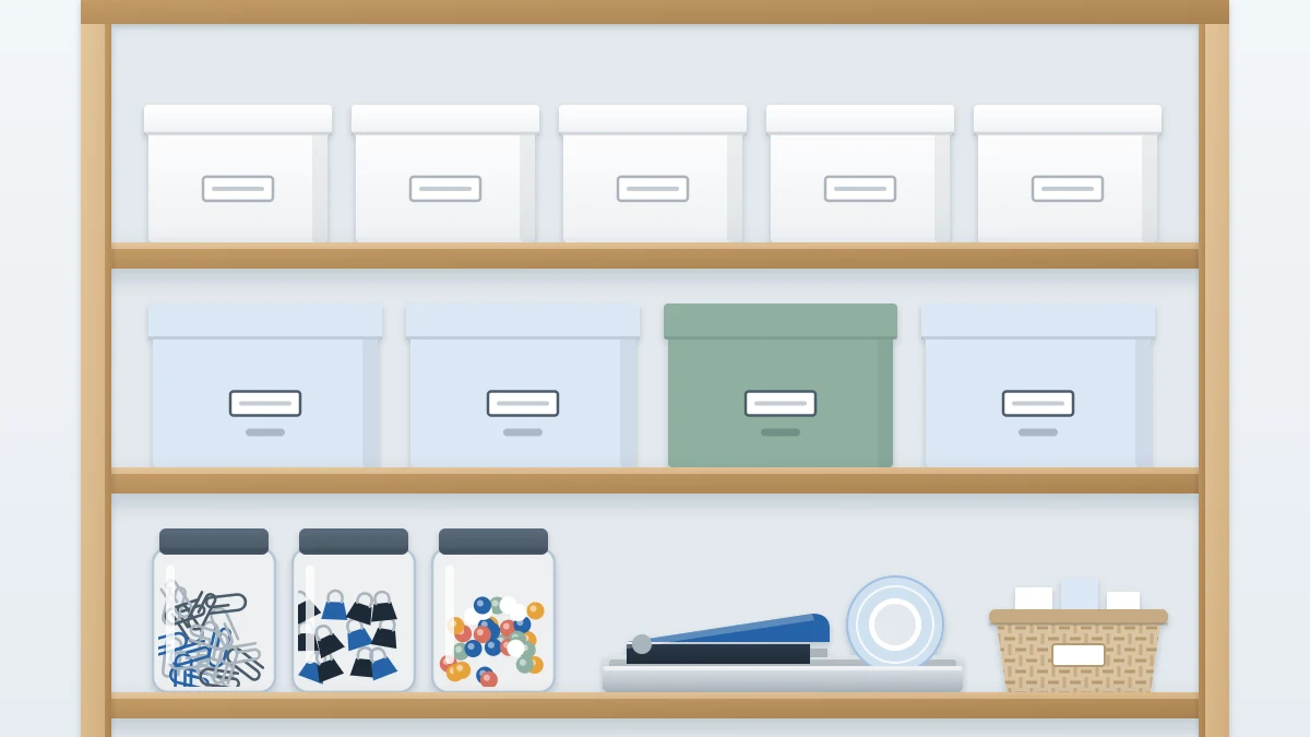 Open shelves with rows of matching lidded boxes, three small jars of clips and pushpins, and a shallow tray with tape and a stapler