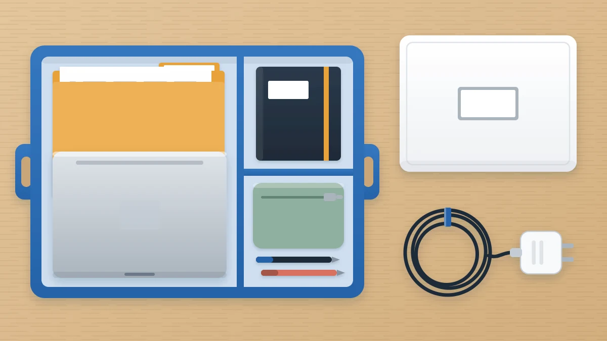 Dining table with an open caddy holding a laptop, notebook, zip pouch and folder, beside a closed lidded box and a coiled charger