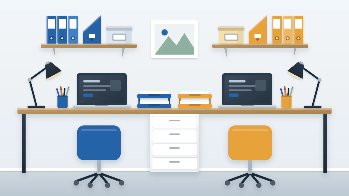 Long desk with two side-by-side workspaces, each with a laptop, lamp and a letter tray in its own color, and a shared drawer unit between